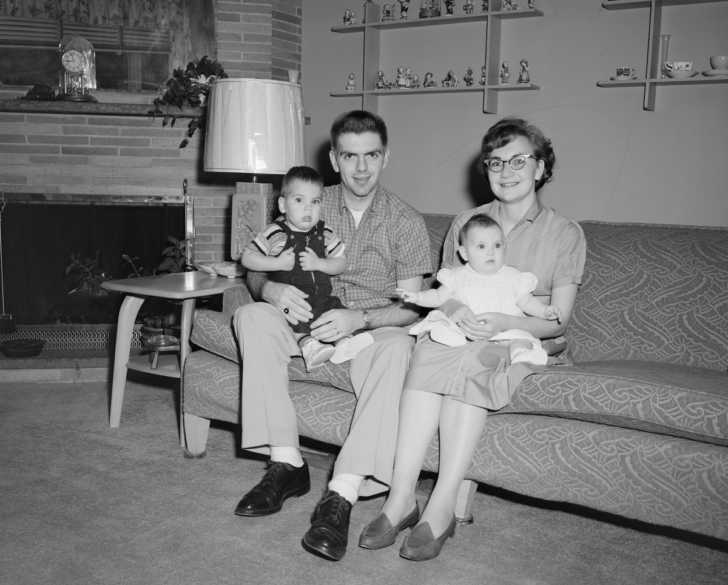 1950s nuclear family sitting on couch