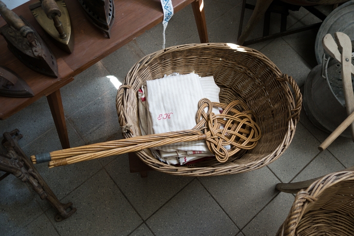 antique rug beaters in a laundry basket