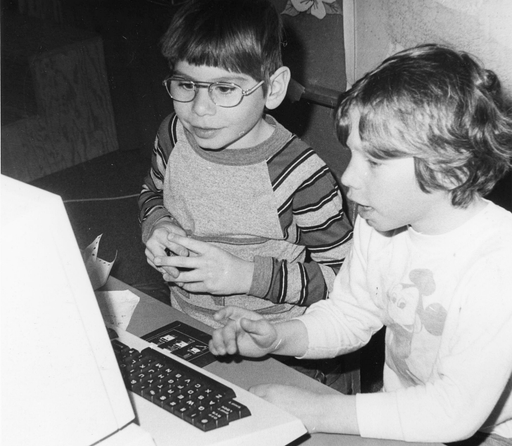 2 kids using an early pc