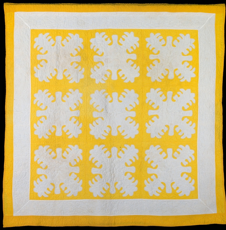 yellow and white Hawaiian quilt depicting breadfruit plants