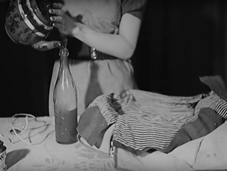 woman pouring hot tea into a glass bottle