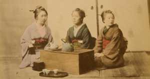 colorized photo of 3 Japanese women having tea from 1877