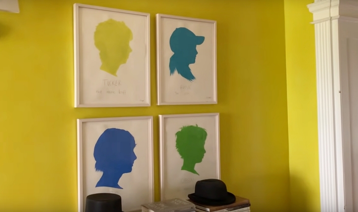 silhouette paintings on yellow wall