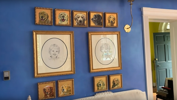 blue wall with paintings of dogs