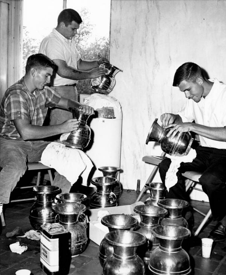 young men cleaning spittoons