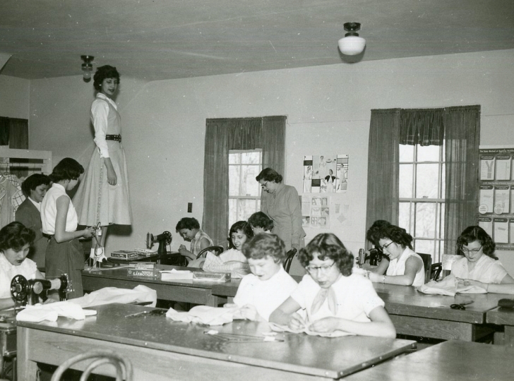 girls learning sewing in school