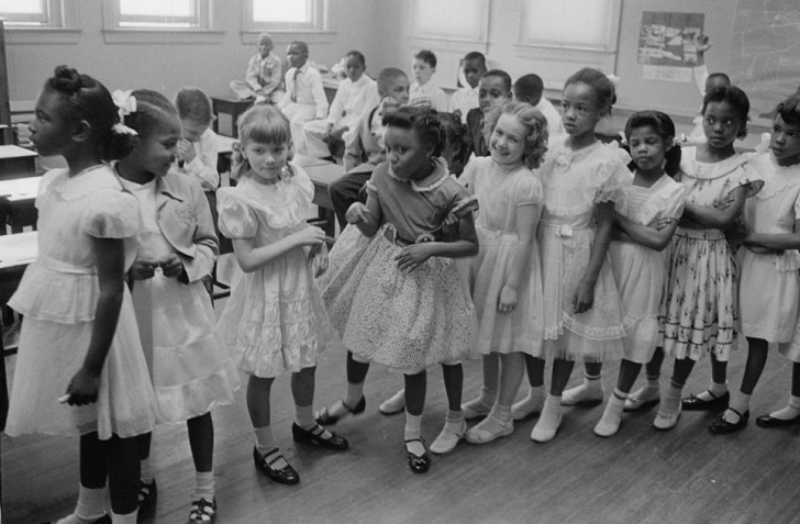 school girls each in a frilly dress and mary janes shoes