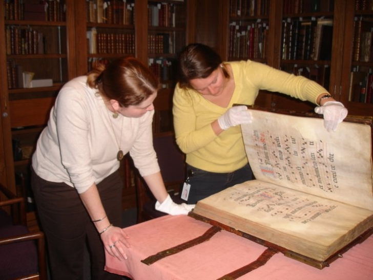 giant manuscript handled with gloves