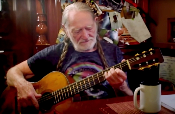 Willie Nelson playing his guitar, Trigger