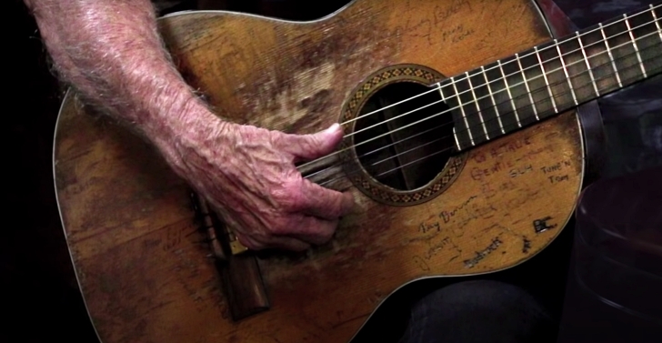 Willie Nelson playing his guitar, Trigger