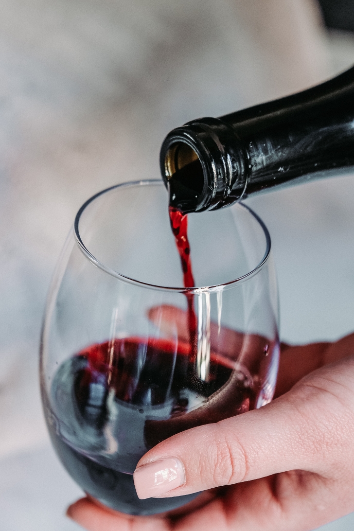 red wine being poured into a wine glass