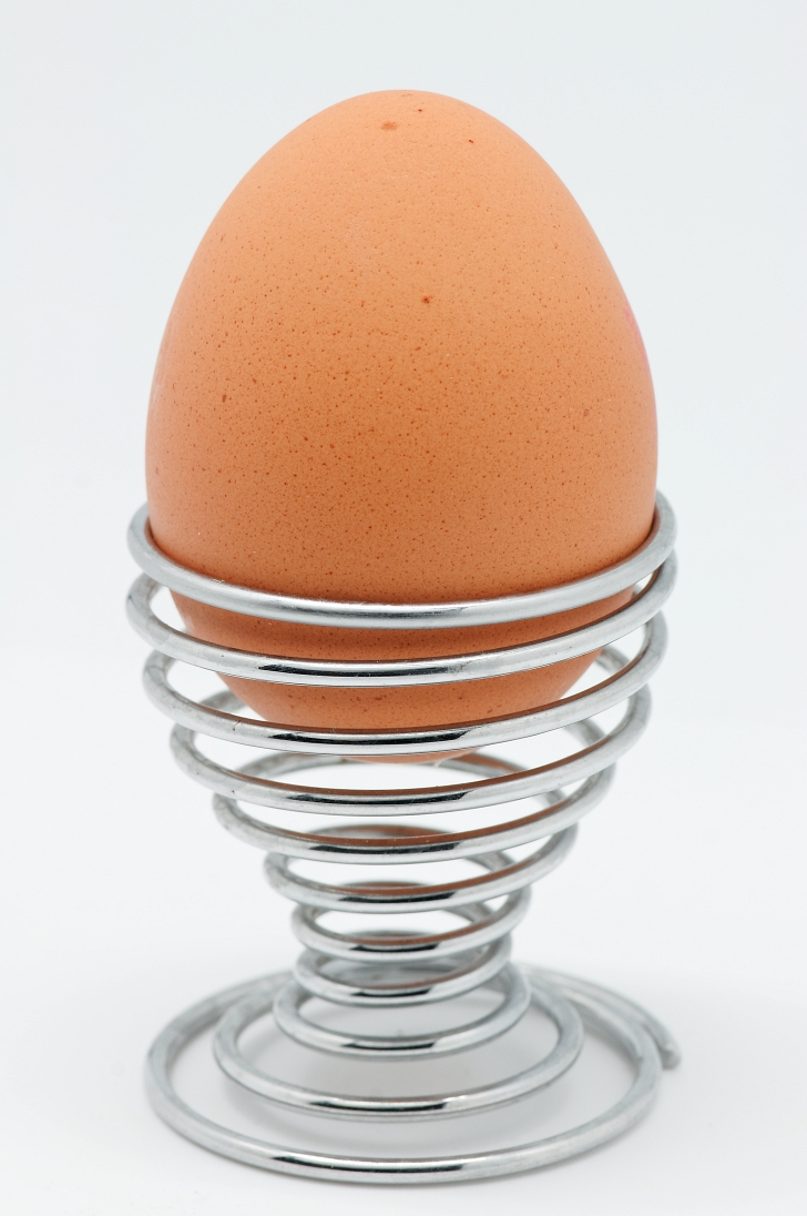 soft boiled egg in metal egg cup