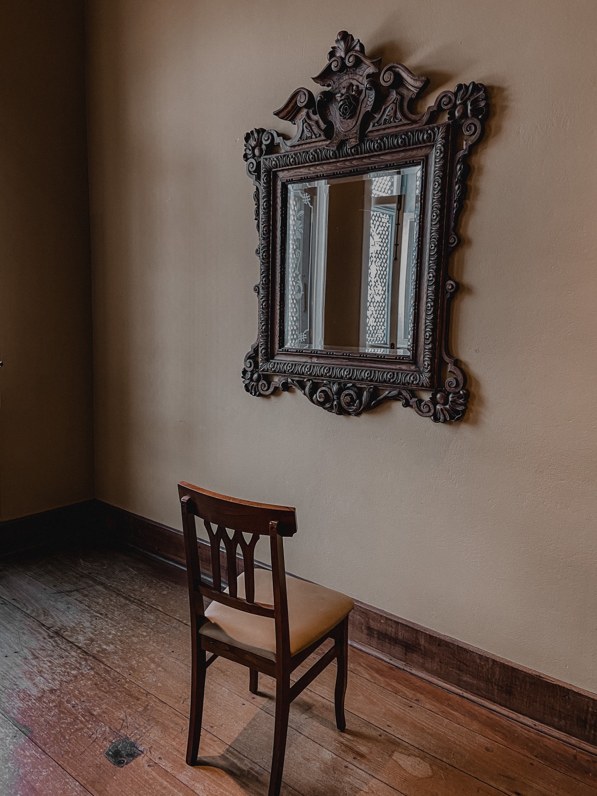 empty chair facing a mirror