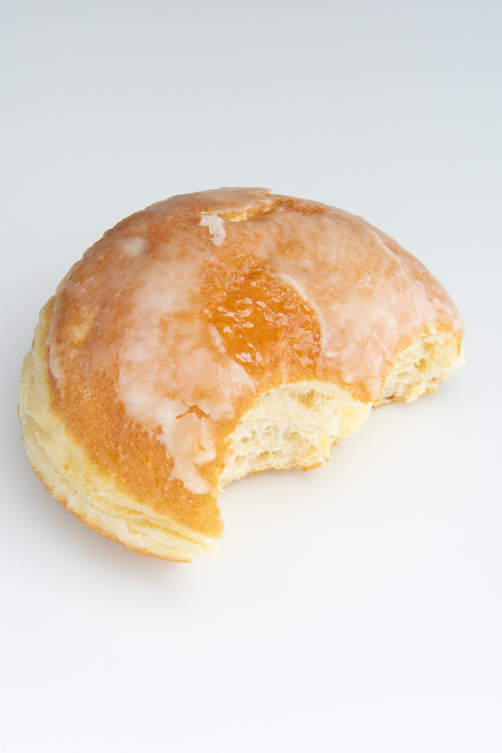 half eaten donut on white background