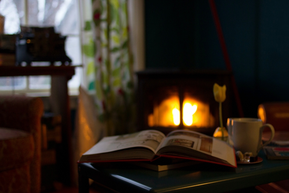 open book by a cozy fire in winter