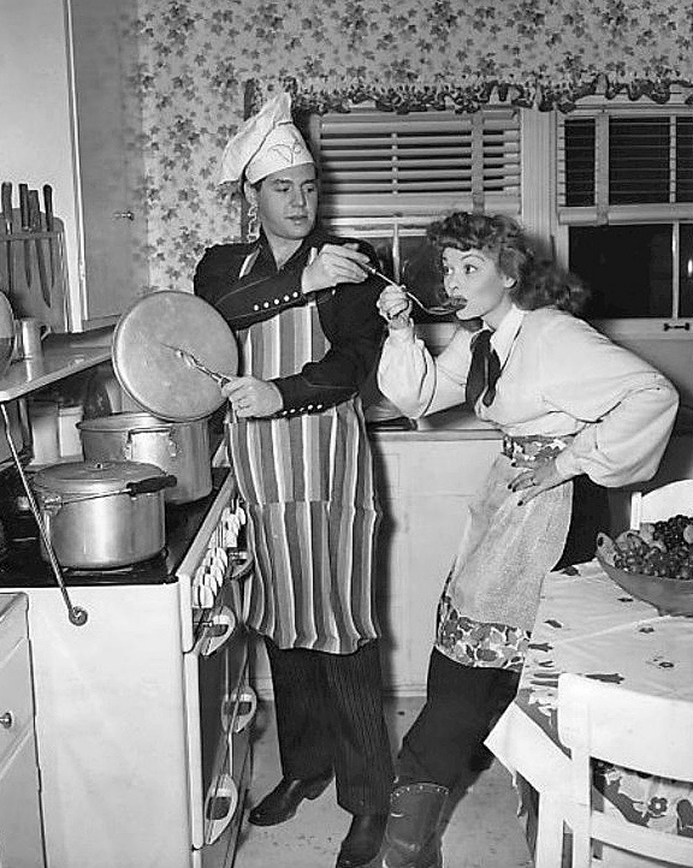 Lucille Ball and Desi Arnaz in home kitchen 1947