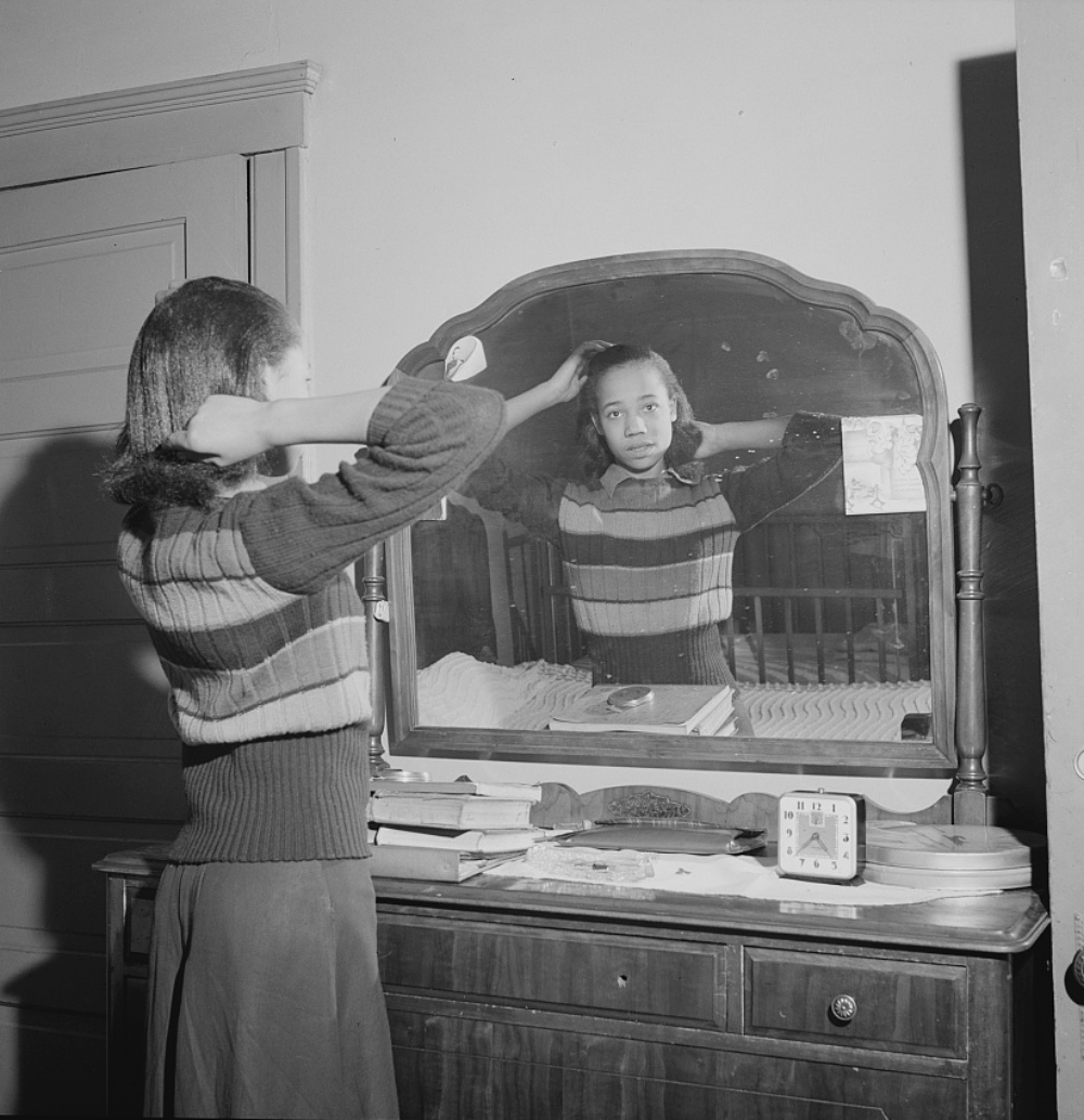 girl brushing her hair in the 1940s