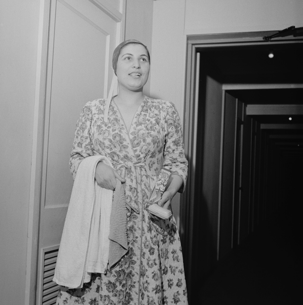 1940s woman heading to the bathrom with her towel and soap