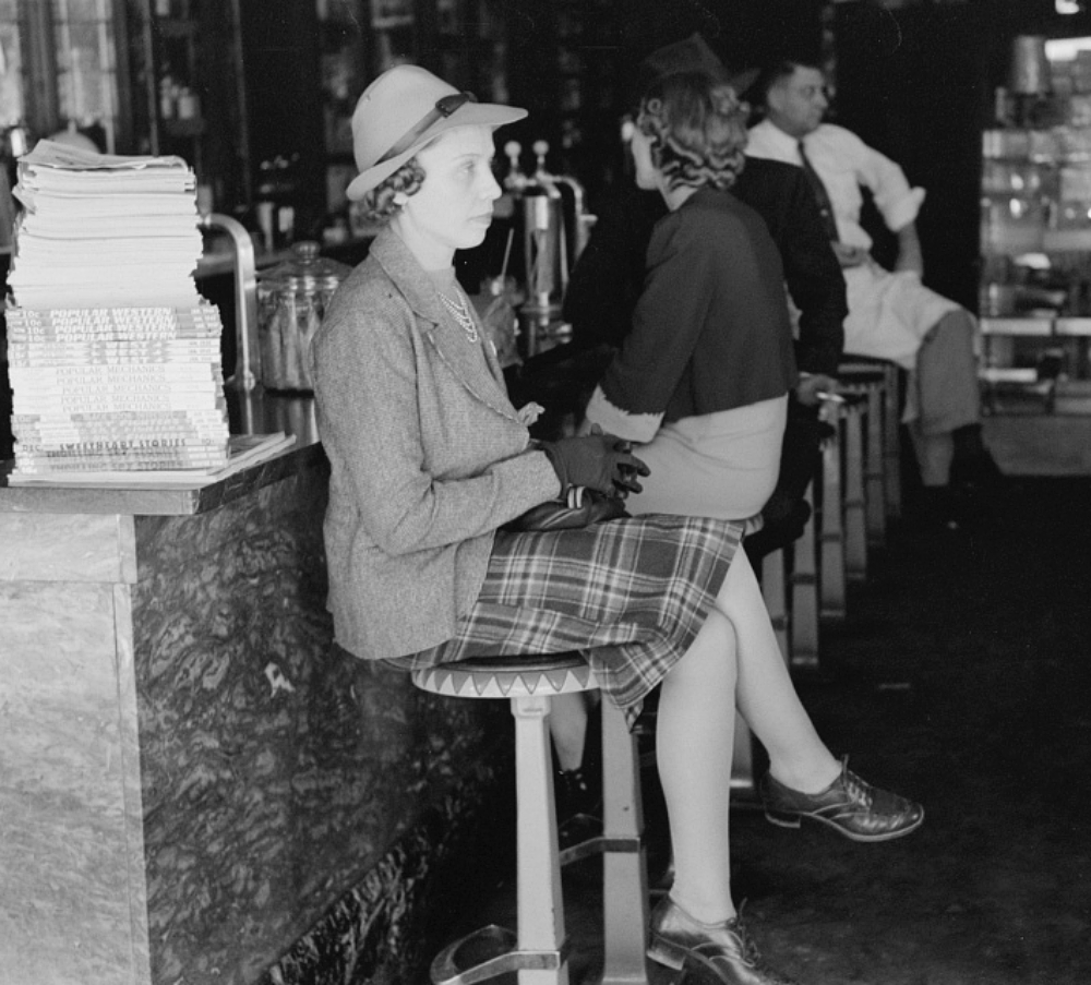 woman crossing her legs at diner counter 1939