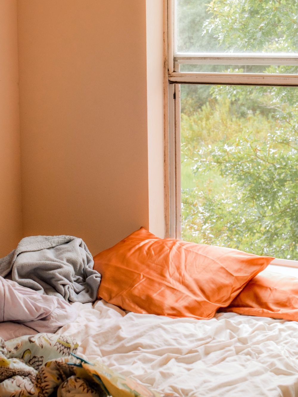 satin pillowcases on unmade bed