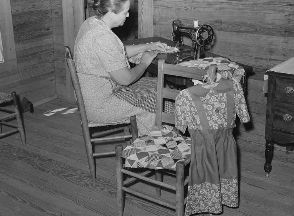 1930s homemaker sewing children's clothes and quilts