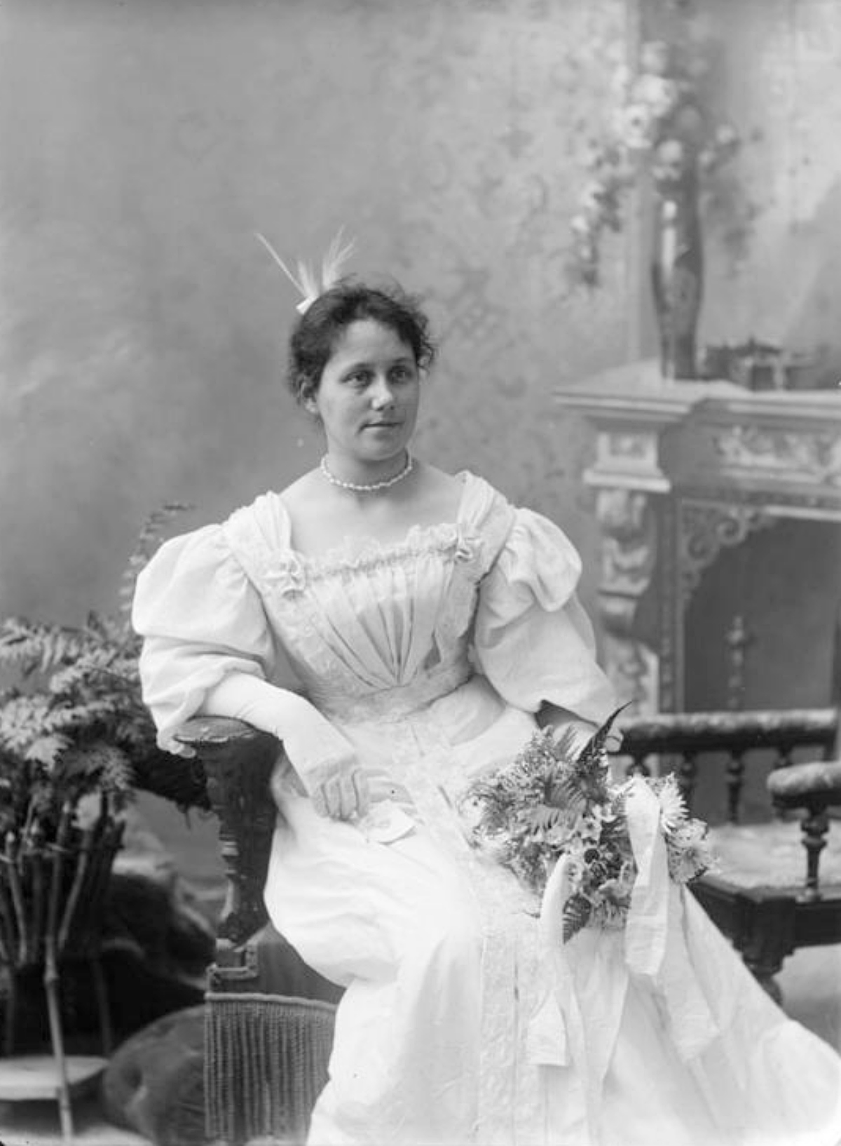 woman with a bouquet and a dance card from late 1800s