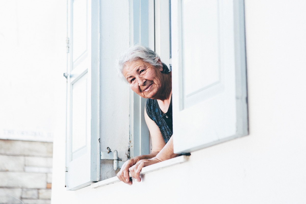 elderly woman looking out the window