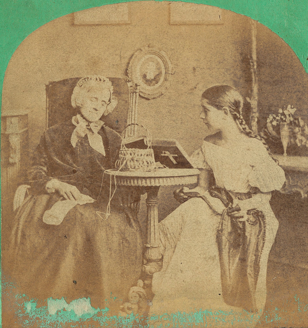 elderly woman and girl darning socks together