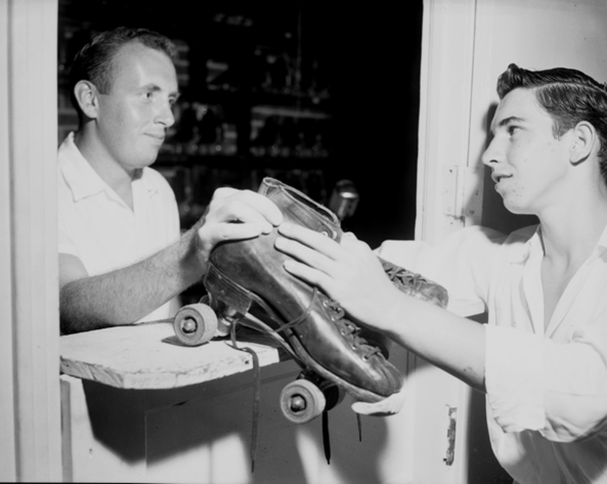 man renting roller skates in the 1950a