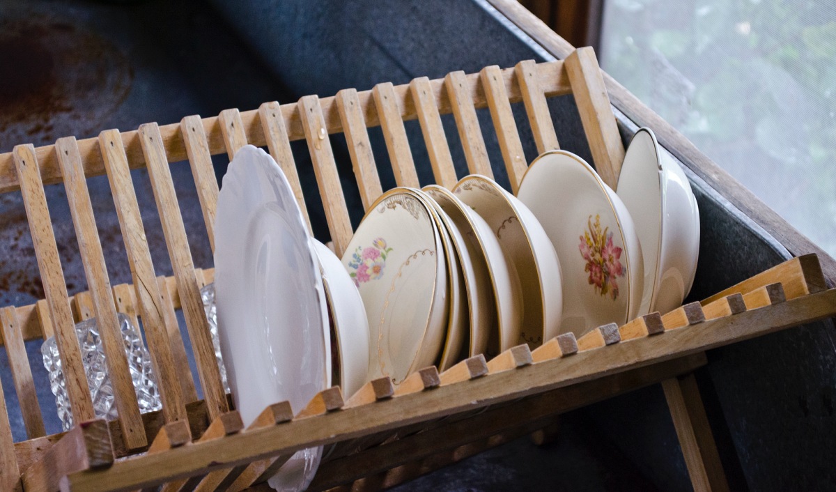 mismatched dishes in a drainer
