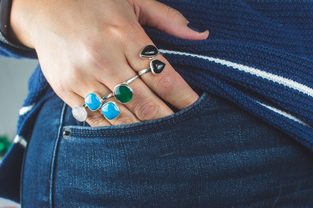 woman with rings putting hand into jeans pocket