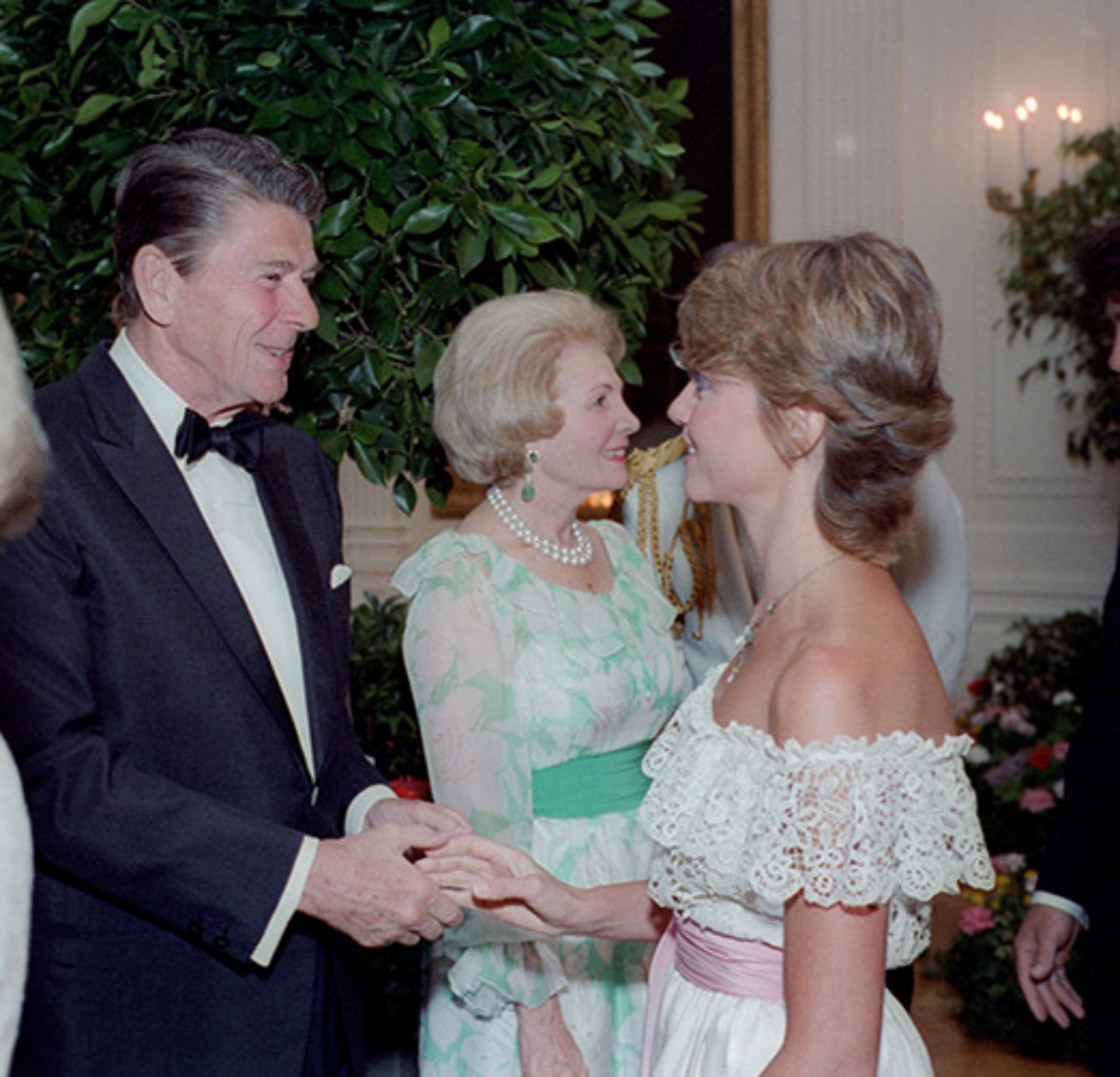 President Reagan shaking hands with Olivia Newton-John during a State Dinner for Prime Minister Fraser of Australia in 1981