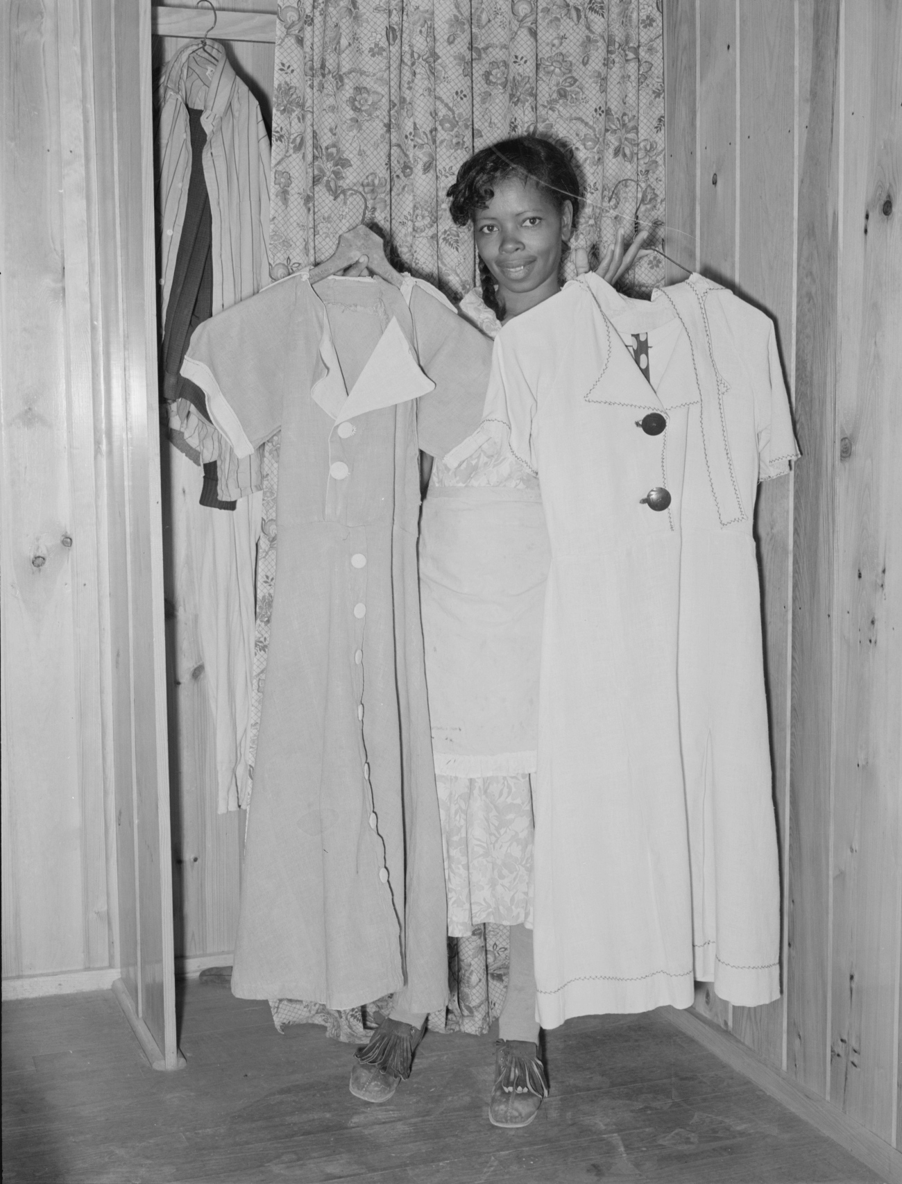 2 Feedsack Dresses Being Held Up By Their Maker 