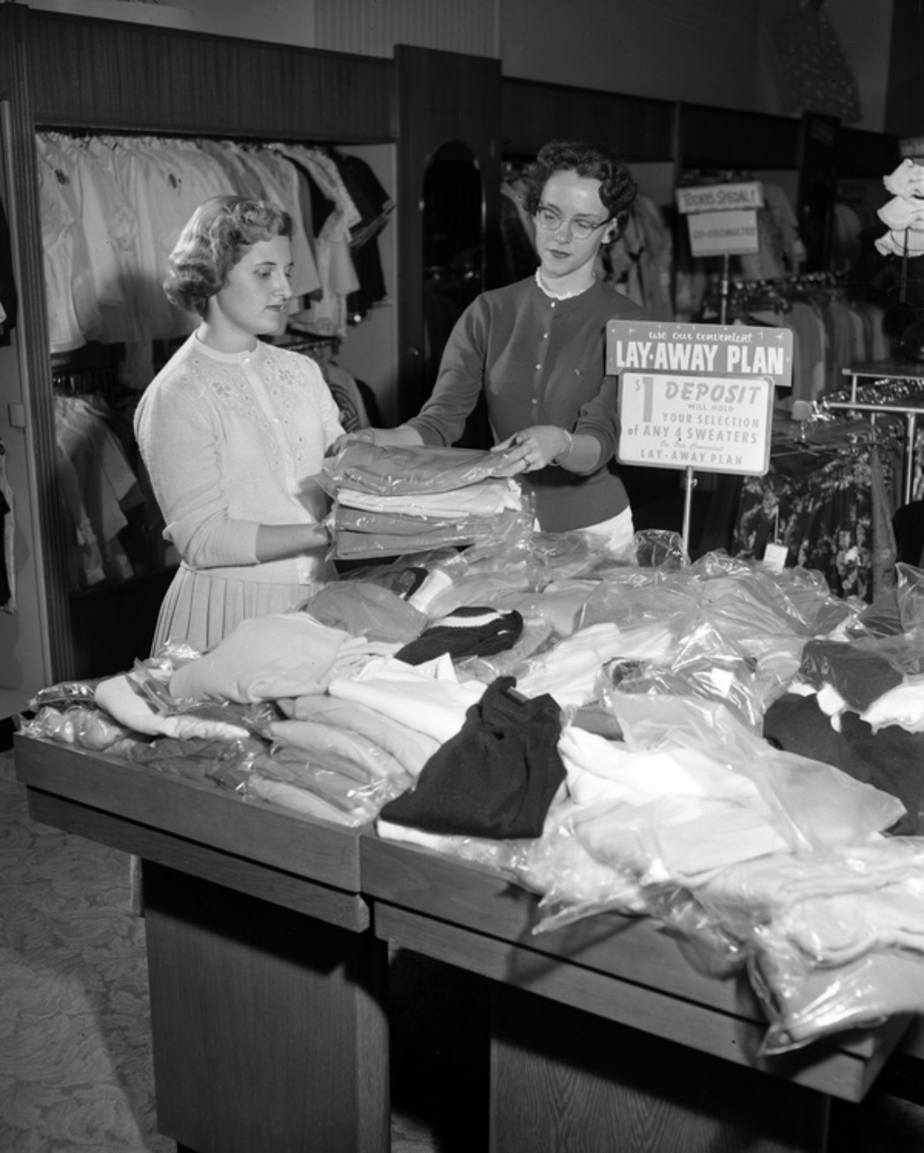 1950s women shopping for sweaters