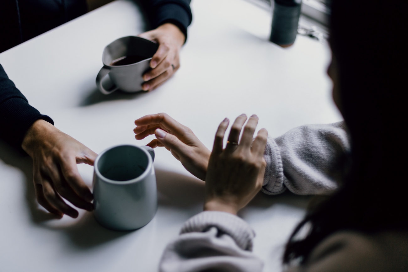 2 people talking over coffee