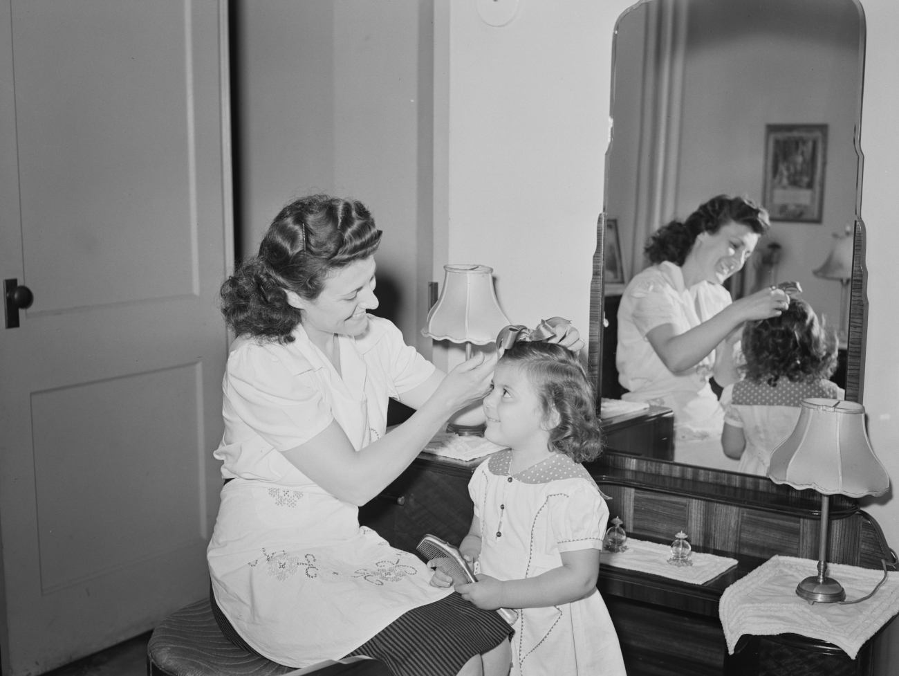 1940s mother doing her daughter's hair