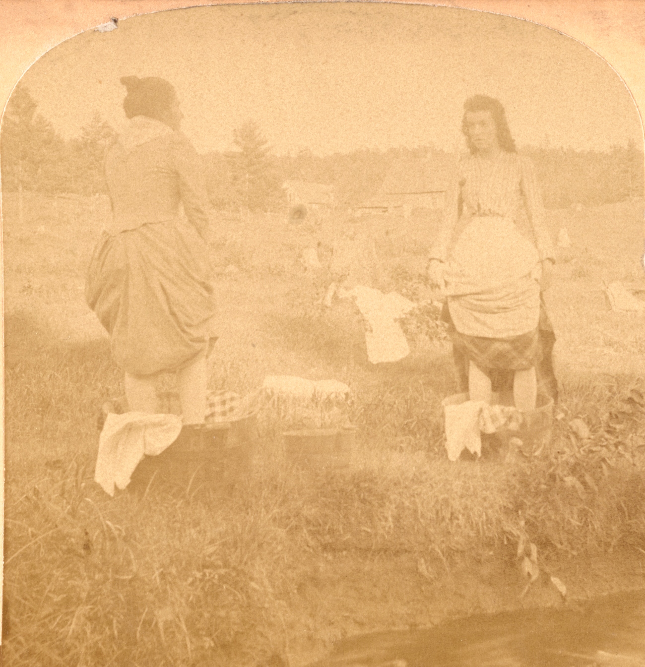 2 women washing clothes in buckets 1800s