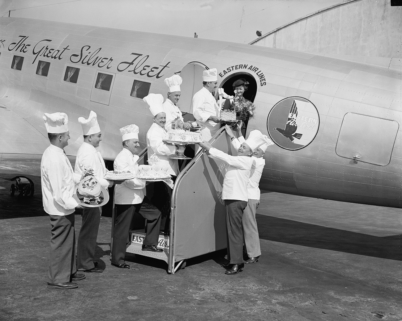 chef's load large cakes onto plane