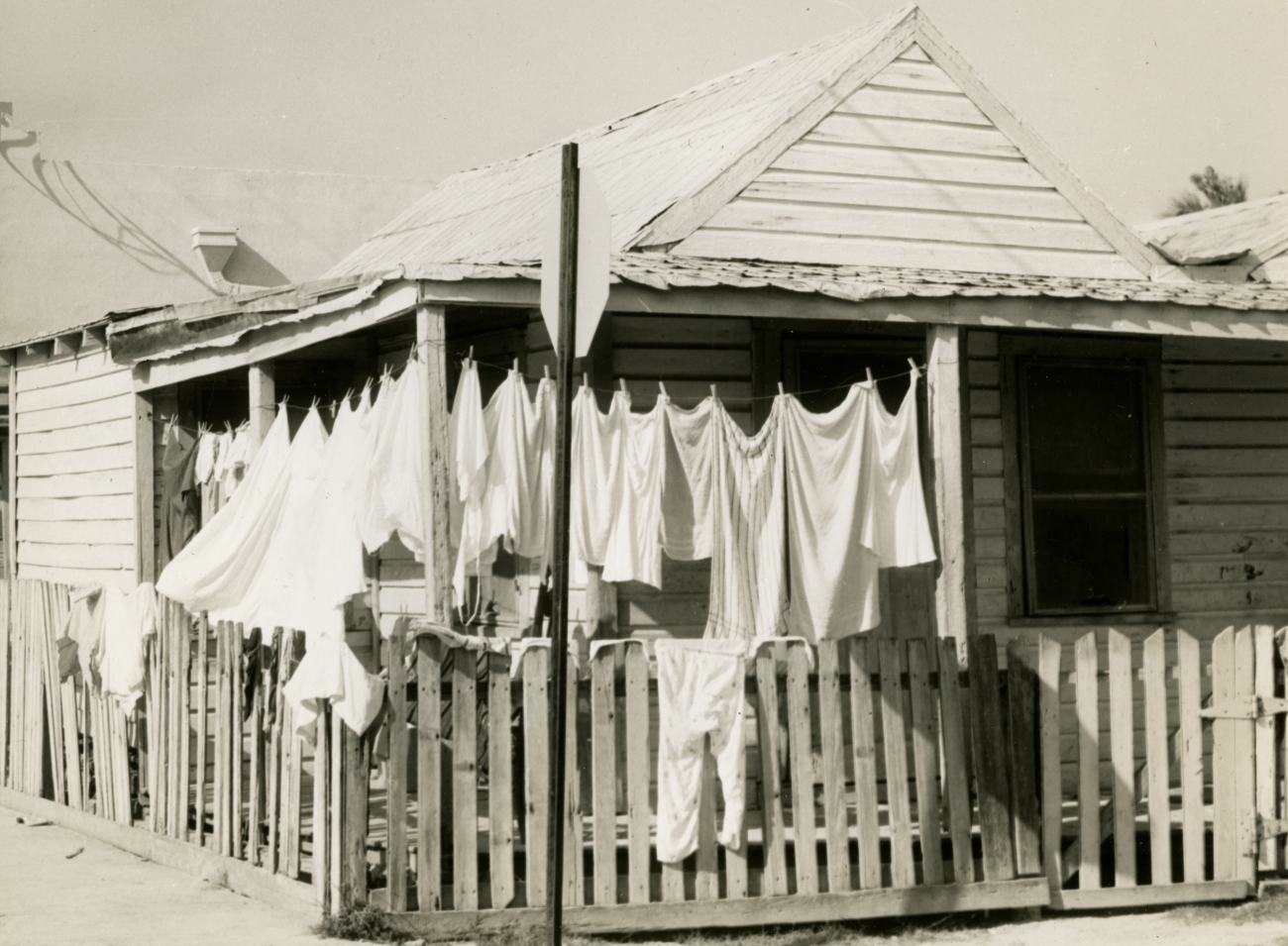 Laundry Hanging Over Picket Fence