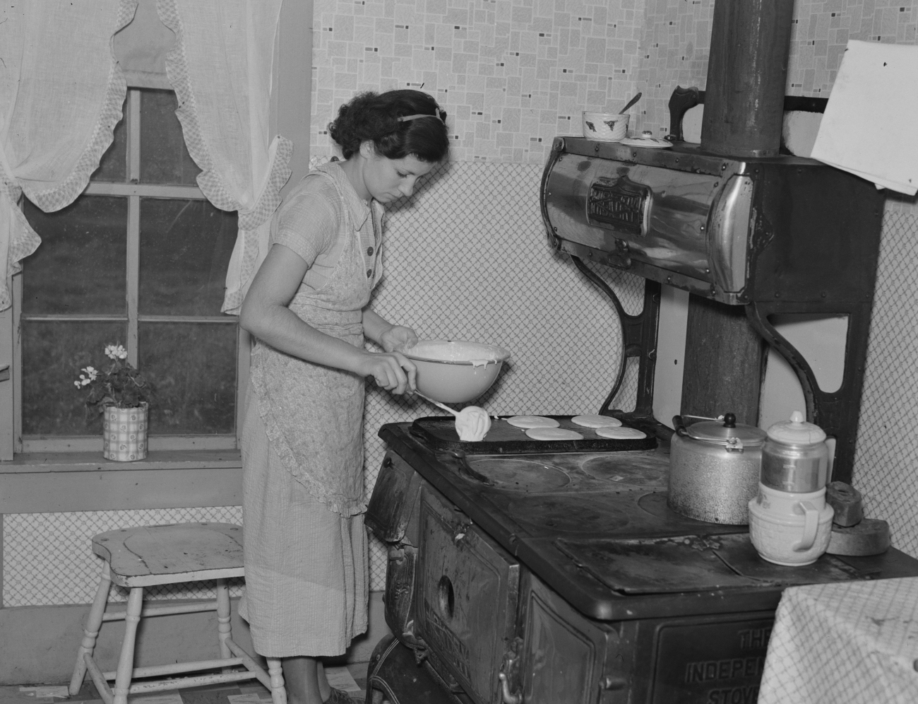 Women Making Pancakes on Stovetop Griddle 1937