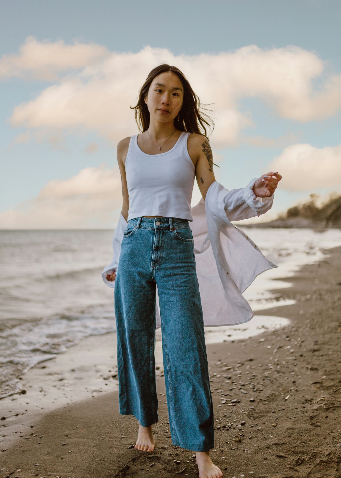 Woman on Beach Wearing Wide Leg Jeans