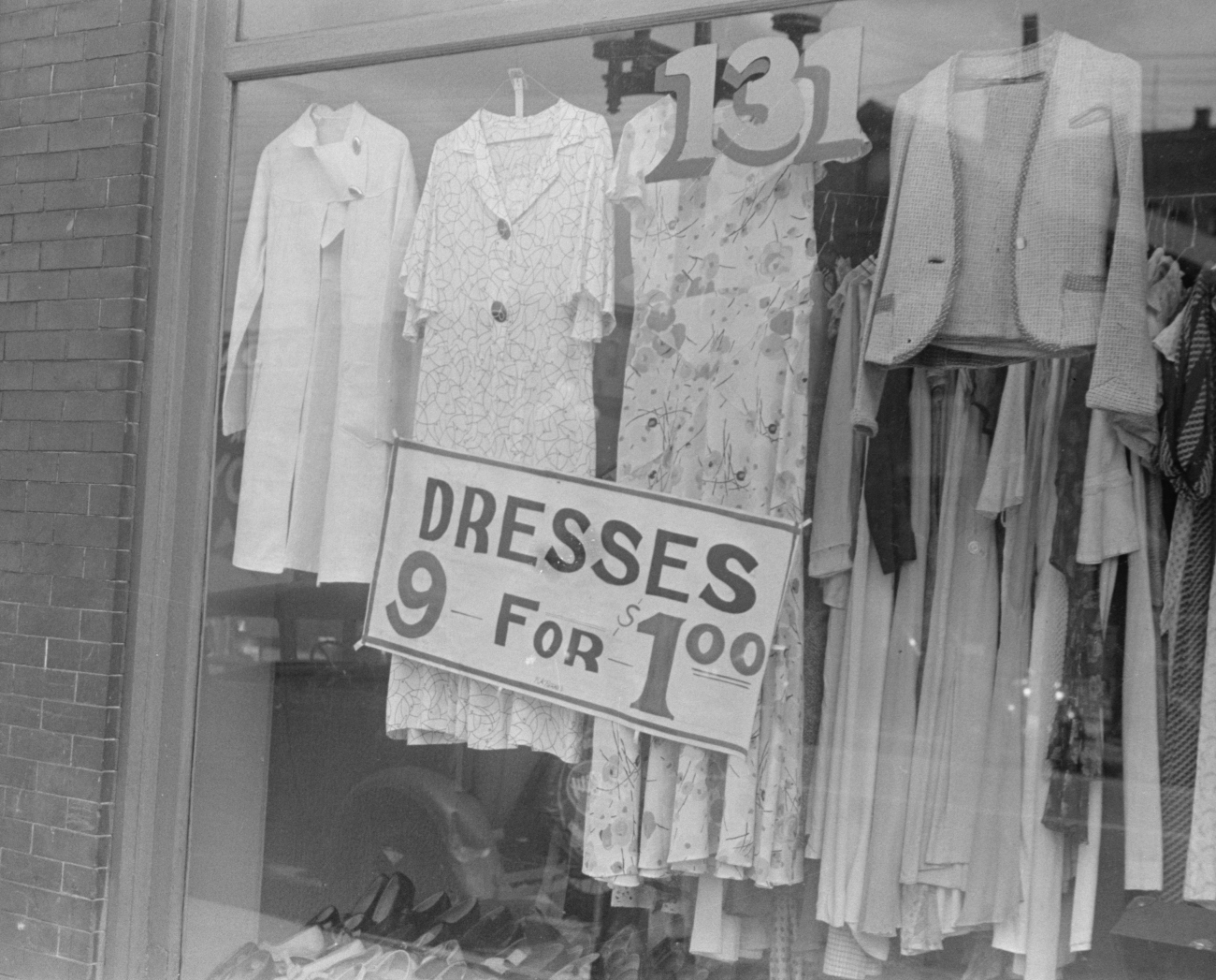 Shop window from 1938 that reads Dresses 9 for One Dollar