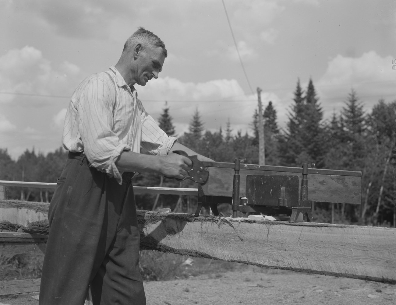 Acadian Man Sawing Wood Photographed 1942