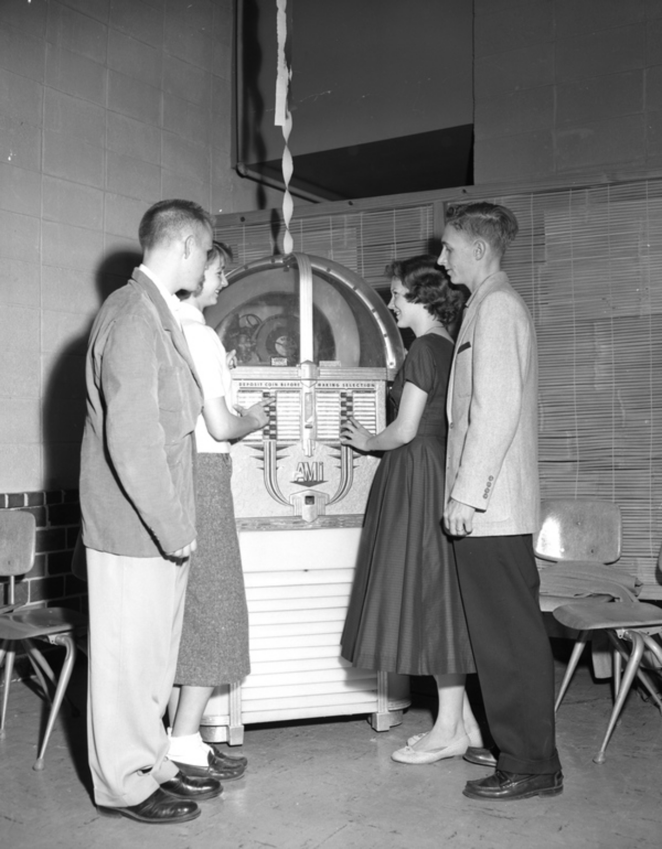 High School Teens on Date in Front of Juke Box School Dance