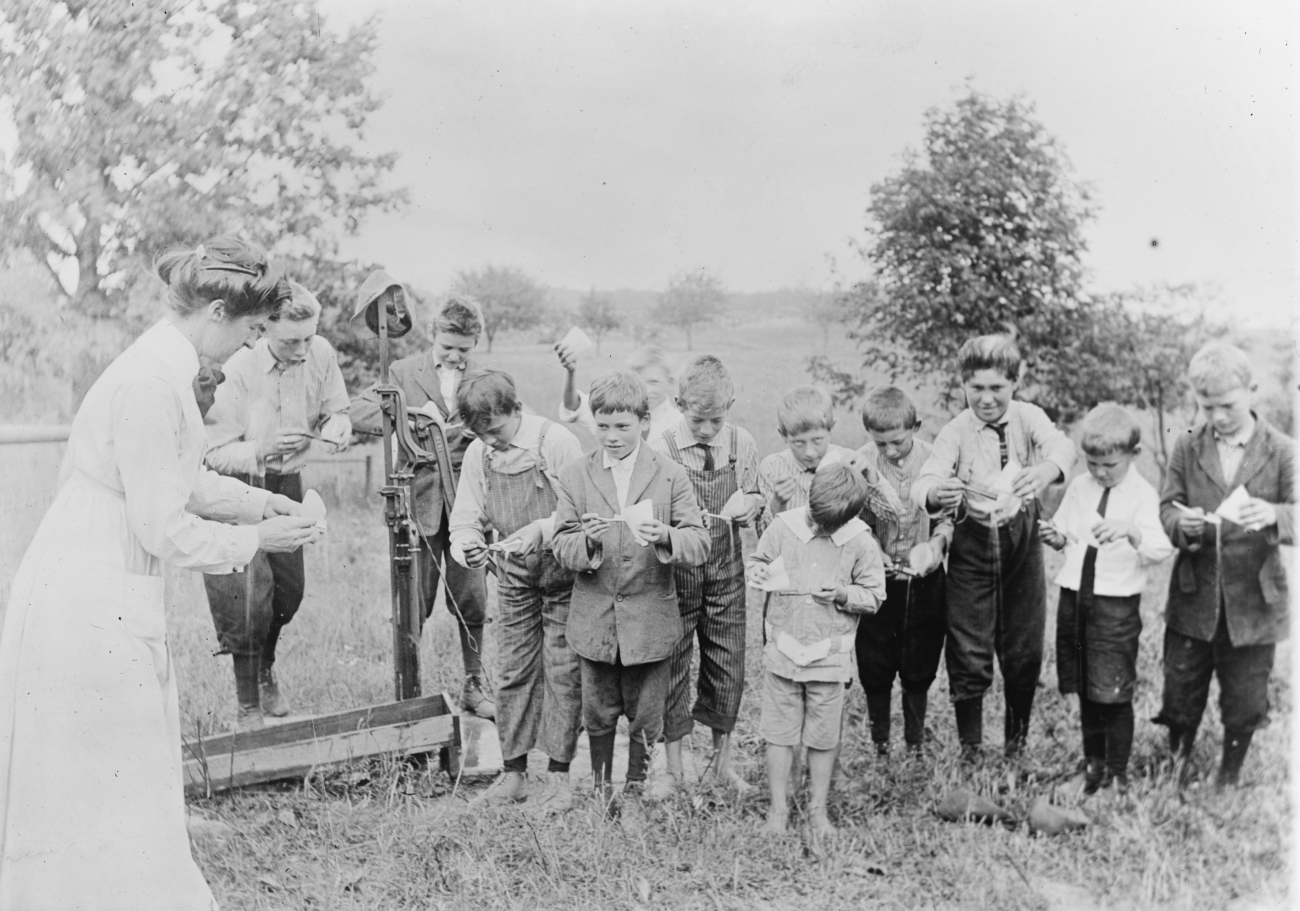 Children Learning How to Brush Teeth at Well Pump