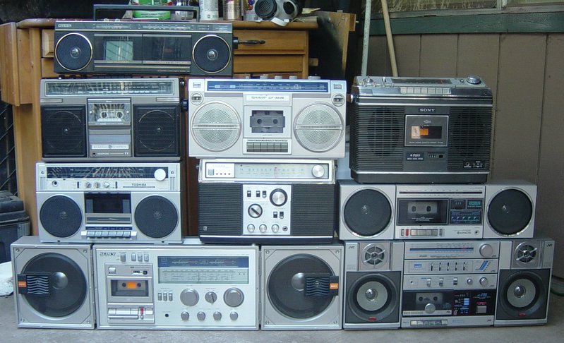 10 boombox stereos stacked on top of each other