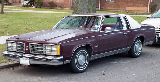 Plum colored Oldsmobile delta 88.